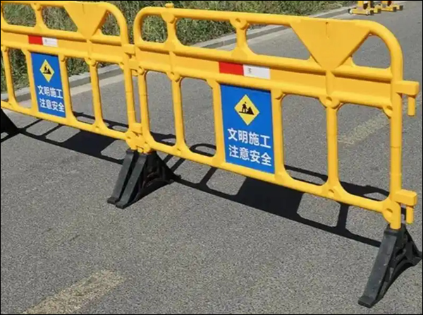 The image shows interlocking plastic barriers commonly used for temporary traffic control or pedestrian management at construction sites, road work, or events. 